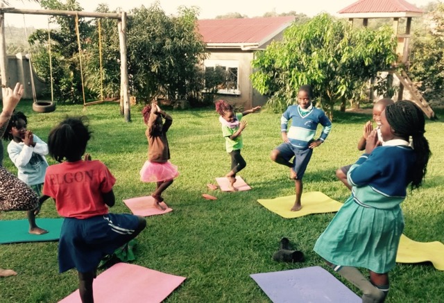 Kinder Raising Voices Children Practicing Yoga